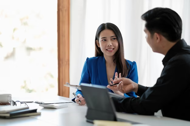 two-colleagues-discussing-data-with-document-data-desk-table-close-up-business-people-meeting_1645-4